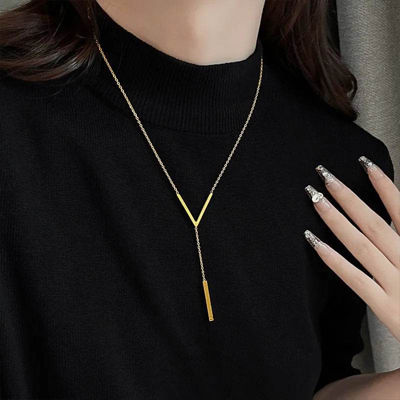 Collier à initiale et pampille sur chaîne dorée