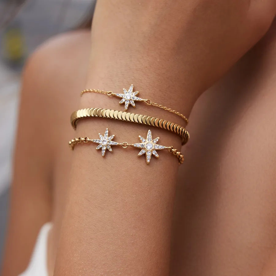 Bracelet à formes géométriques serties de zircons, acier doré