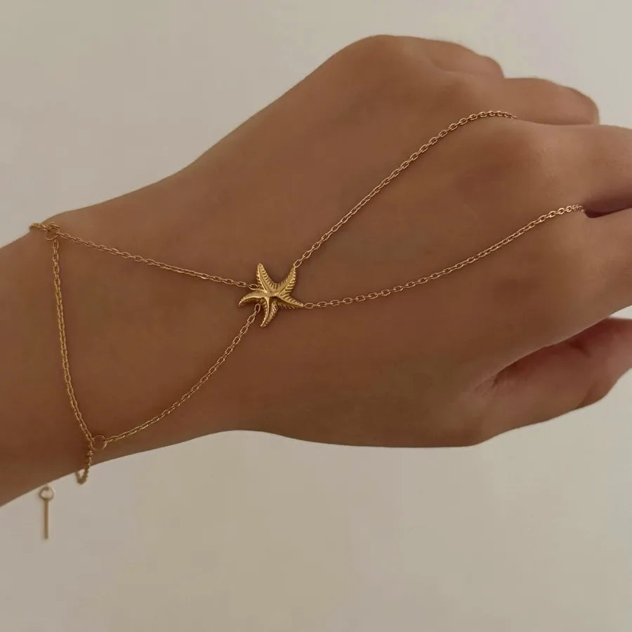 Bracelet de main étoile de mer relié à l'anneau, acier doré