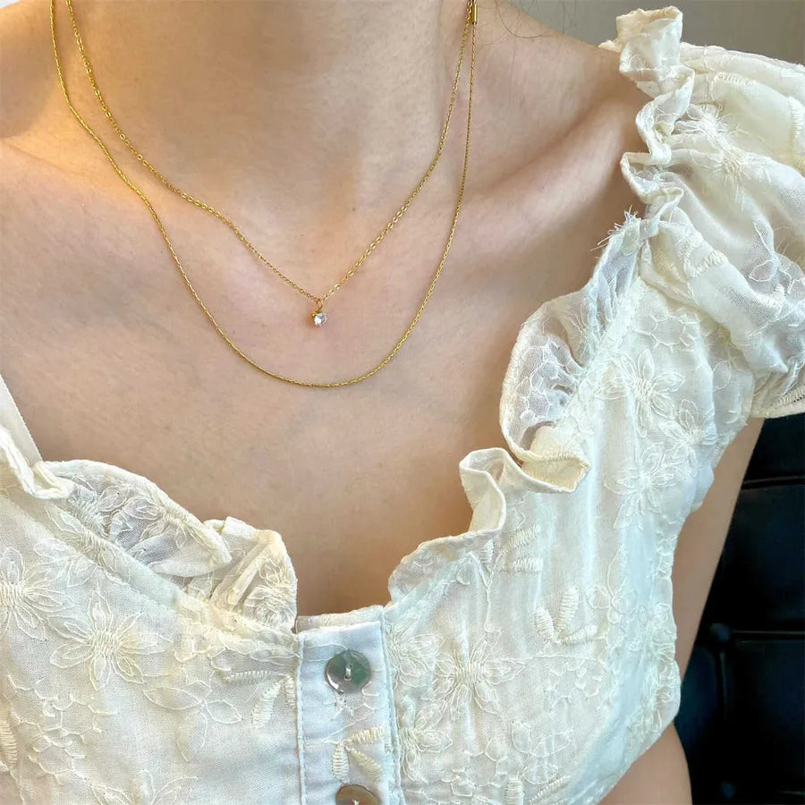 Collier à deux rangs de longueurs différentes, acier doré